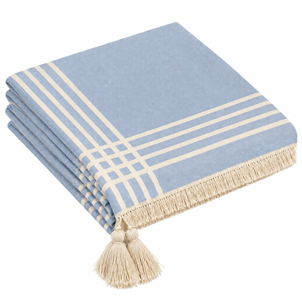 L4 folded blue grid tablecloth with tassels hanging from original outer corner