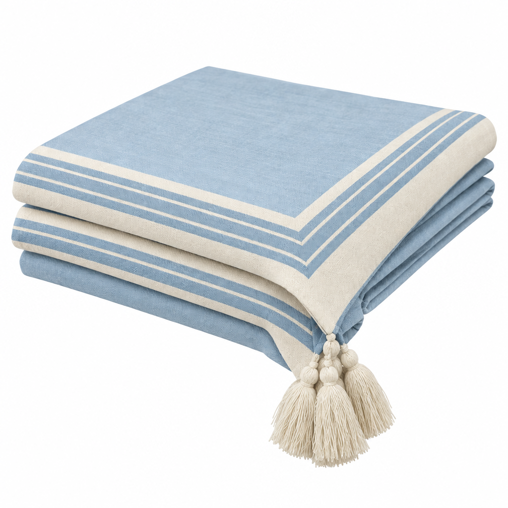L2 light blue tassel tablecloth neatly folded in quarters on white background